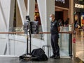 Security guard wearing a mask operates a FLIR thermal imaging temperature camera scanner at Jewel Mall, Changi Airport, Singapore Royalty Free Stock Photo